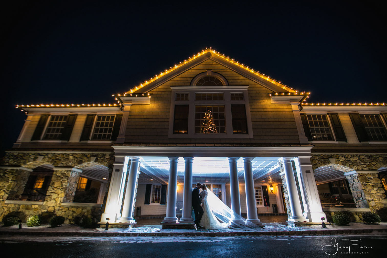 Bride and Groom Front of Hotel at night